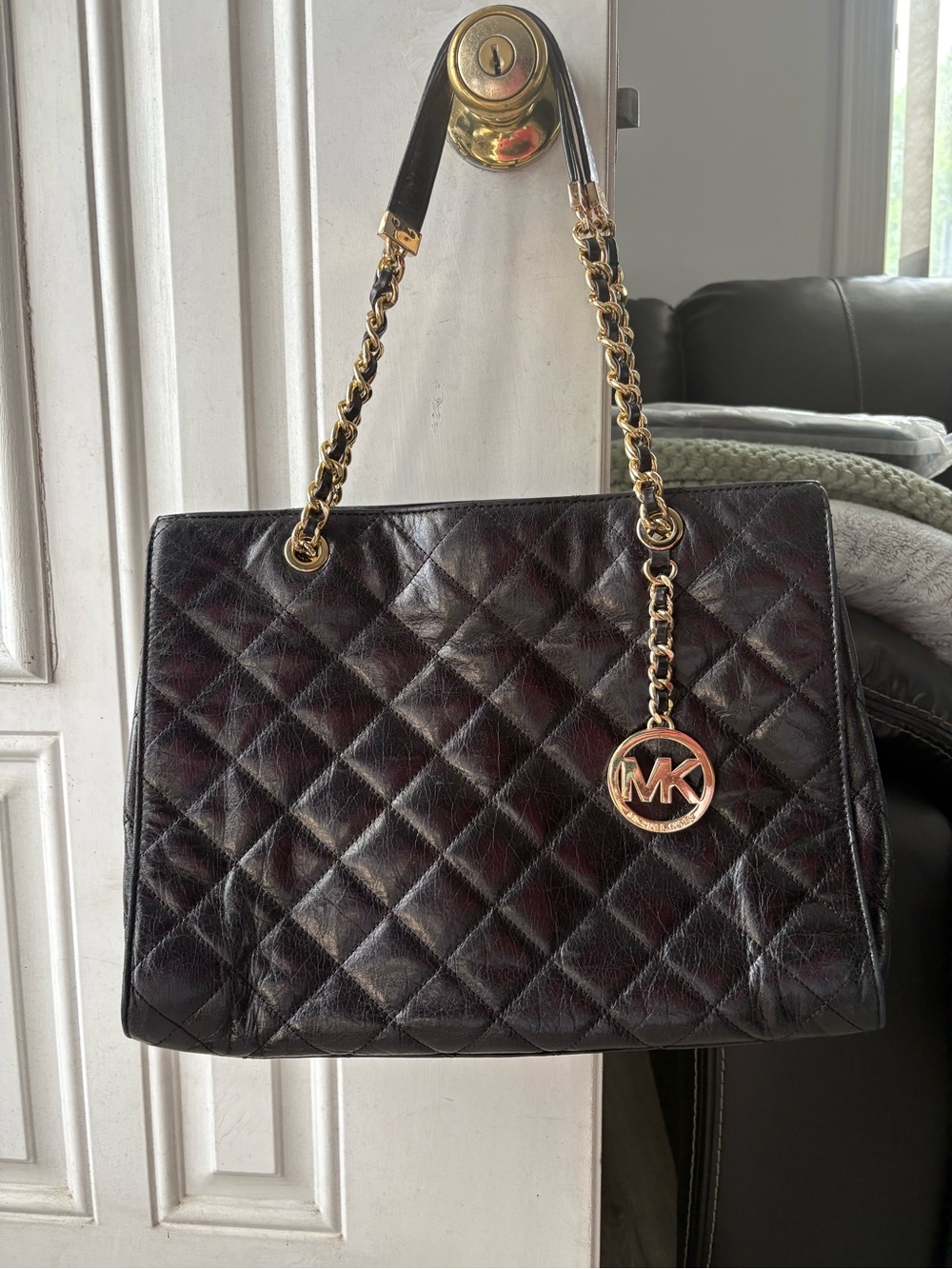 Michael Kors Quilted Leather Shoulder Bag in Black with gold chain.